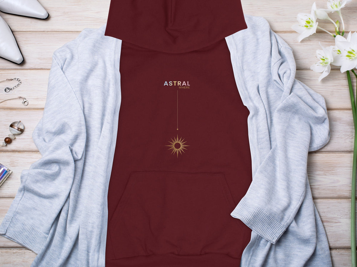 Maroon hoodie with "ASTRAL WHERE" text and golden sun graphic.