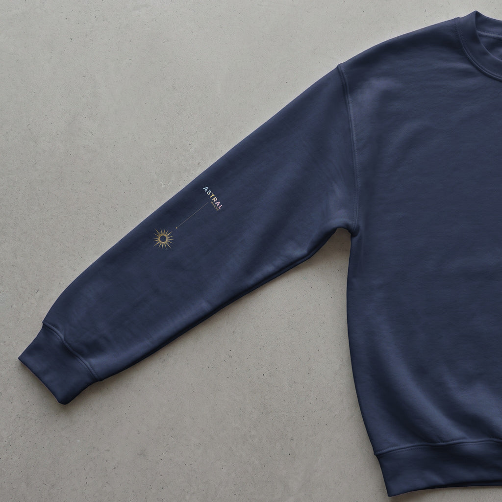 Navy sweatshirt with gold celestial graphic and "ASTRAL WHERE" text.