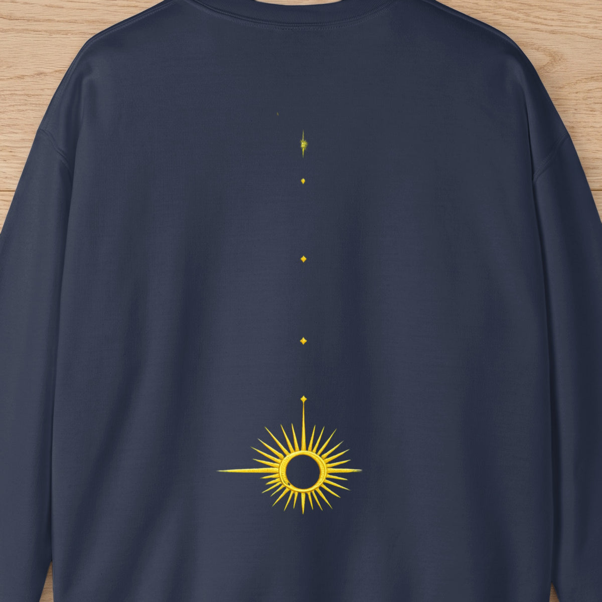 Navy sweatshirt with a minimalist yellow sunburst design and three small yellow dots above.