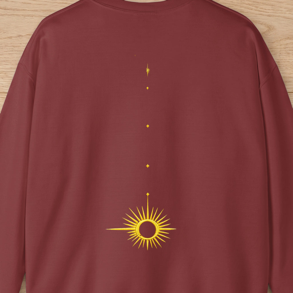 Maroon sweatshirt with embroidered gold sun and starburst design down the back.