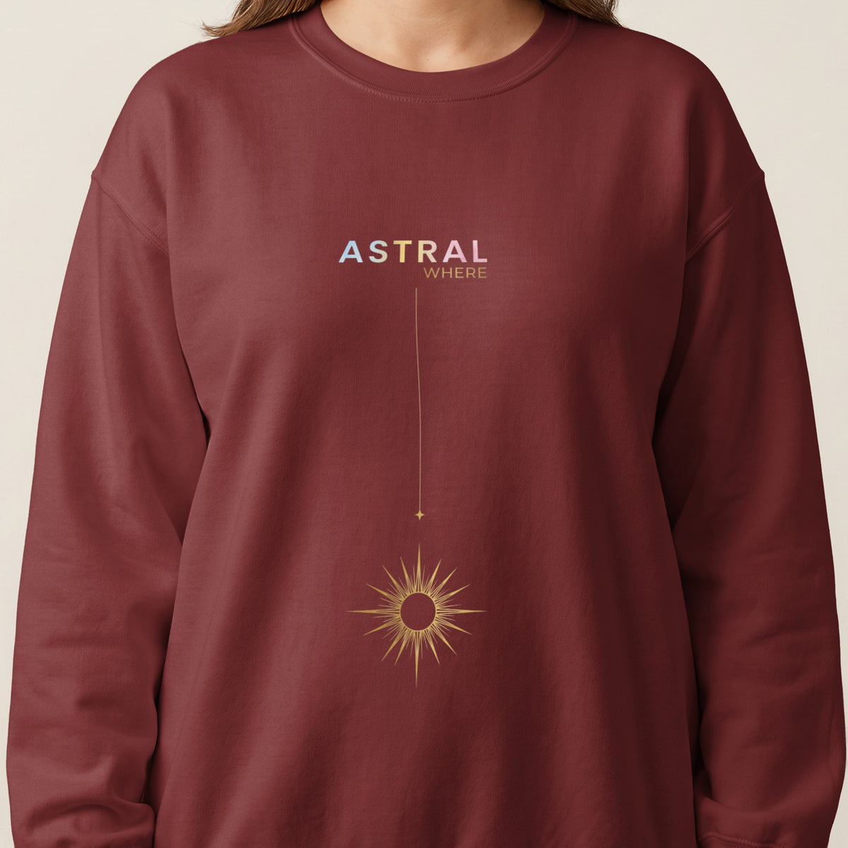Maroon sweatshirt with "ASTRAL WHERE" text and a golden sunburst graphic.
